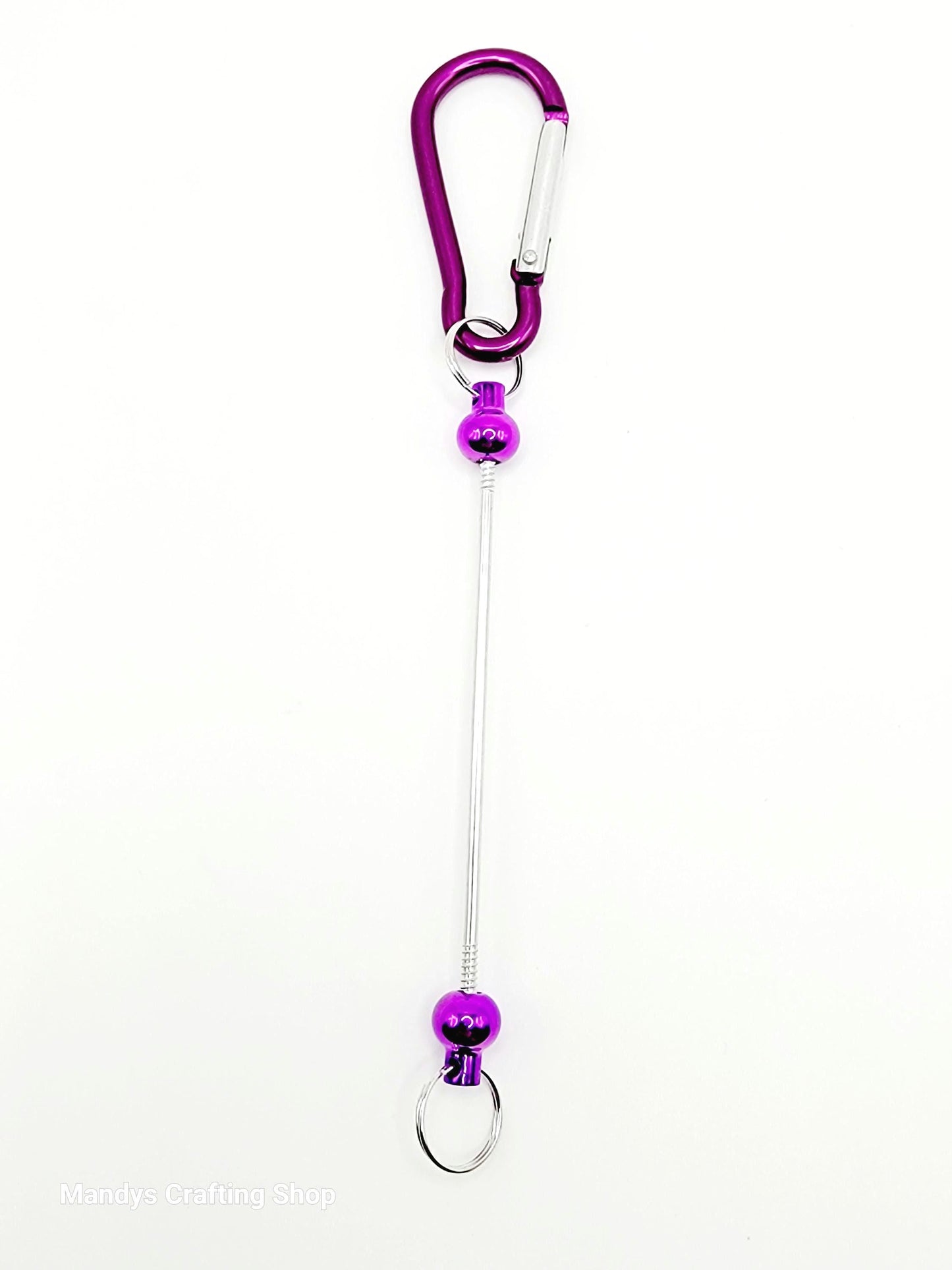 Purple carabiner with a long string on a white background