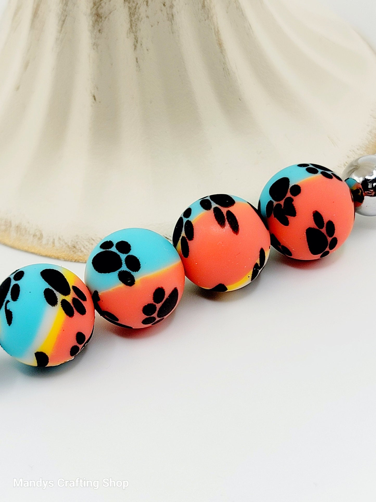 15mm Printed Turquoise, Yellow, & Orange Paw Print Silicone Beads – Round Swirl Paw Print Beads for Pens & Wristlets
