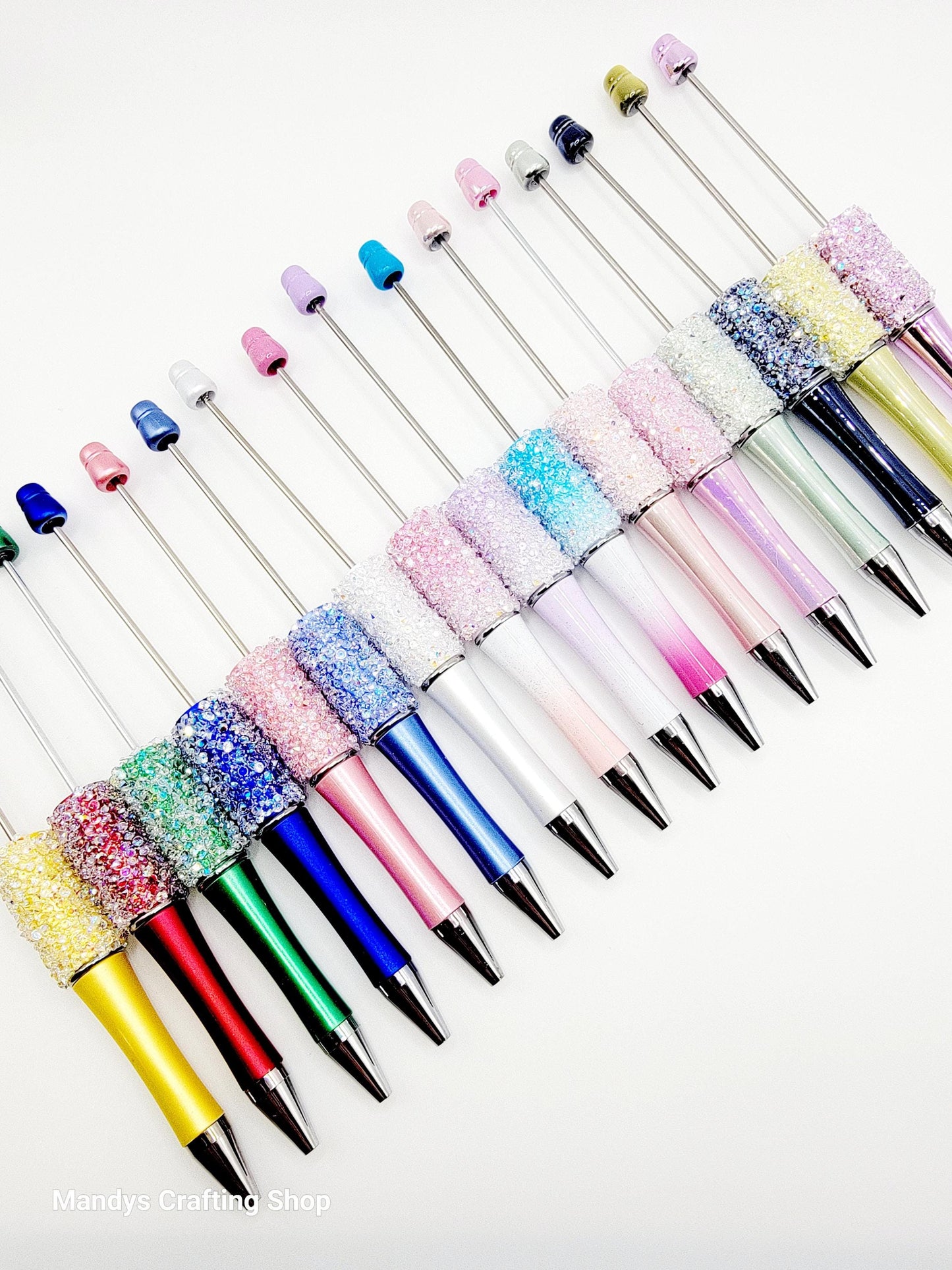 Colorful pens with decorative caps on a white background