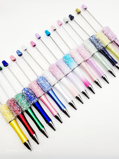 Colorful pens with decorative caps on a white background