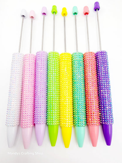 Colorful beaded pen caps on a white background