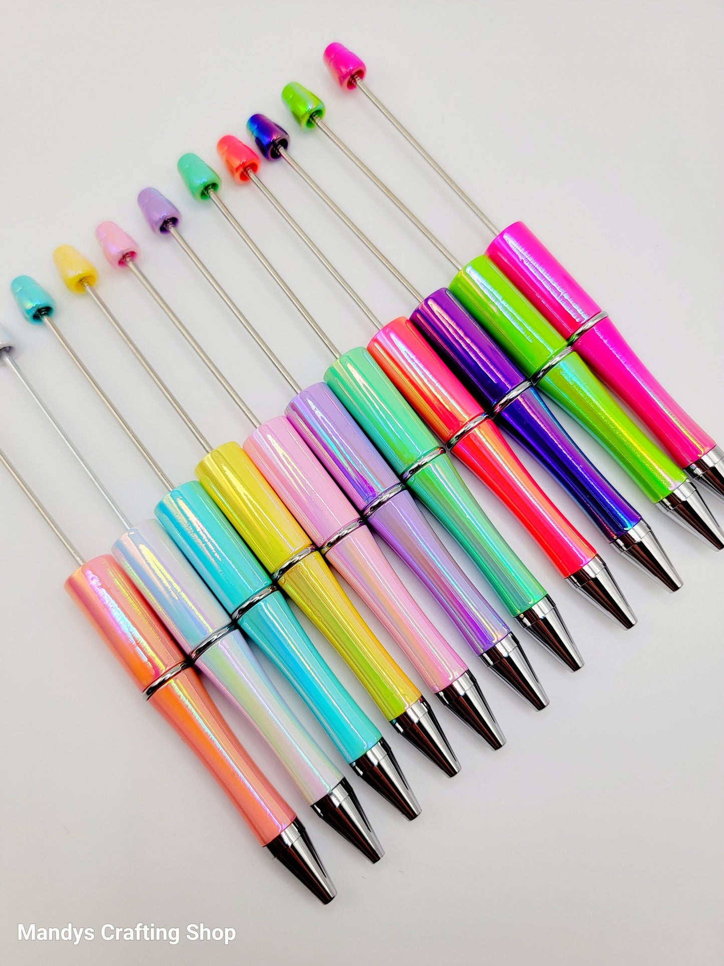 Colorful beadable pens with multicolored tips on a white background, branded 'Mandy's Crafting Shop'.