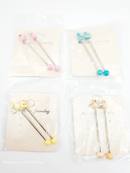 Set of four decorative sticks with colorful beads and butterfly designs on a white background.