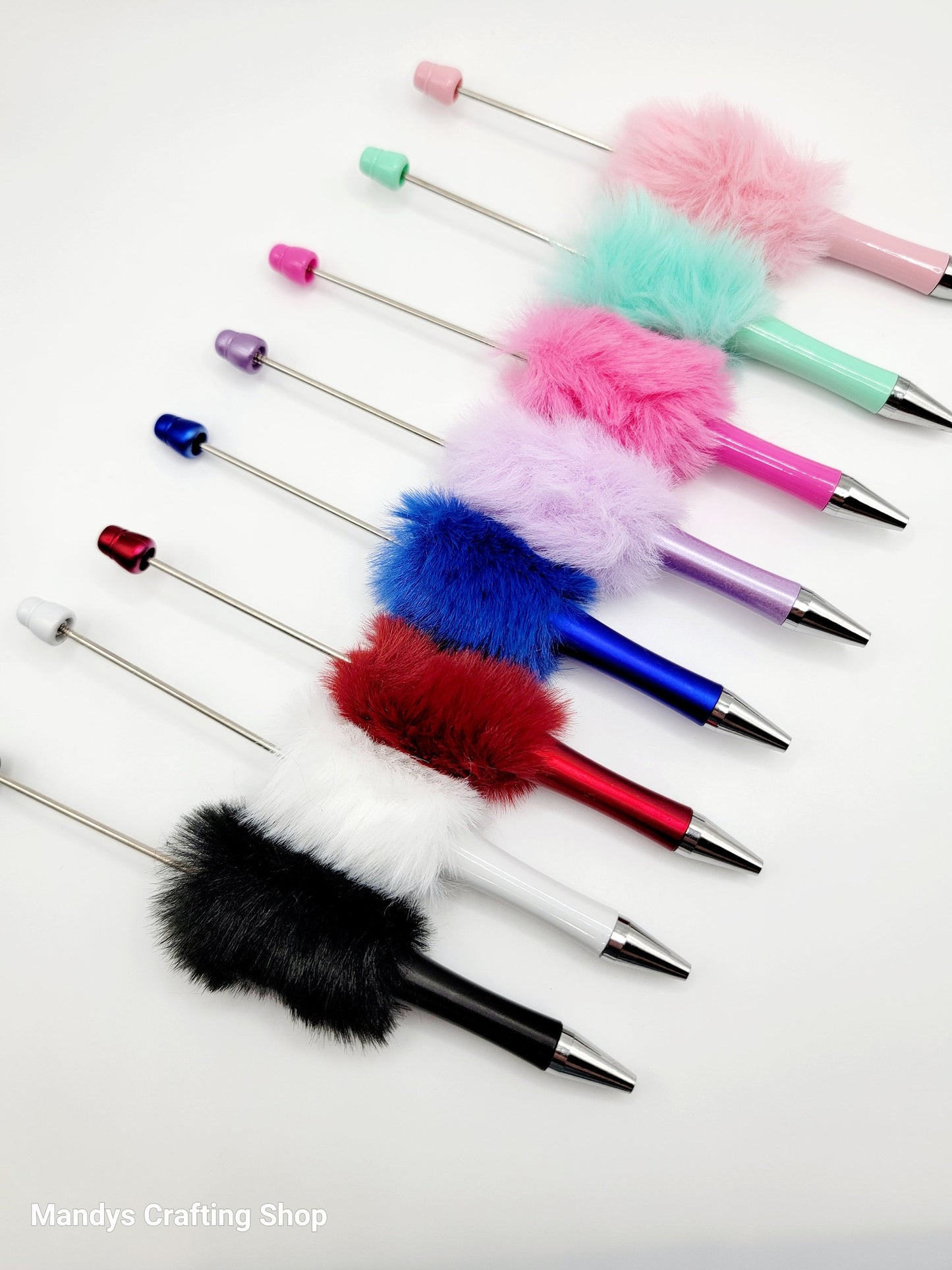Colorful pens with fuzzy ends on a white background, featuring the brand 'Mandy's Crafting Shop'.