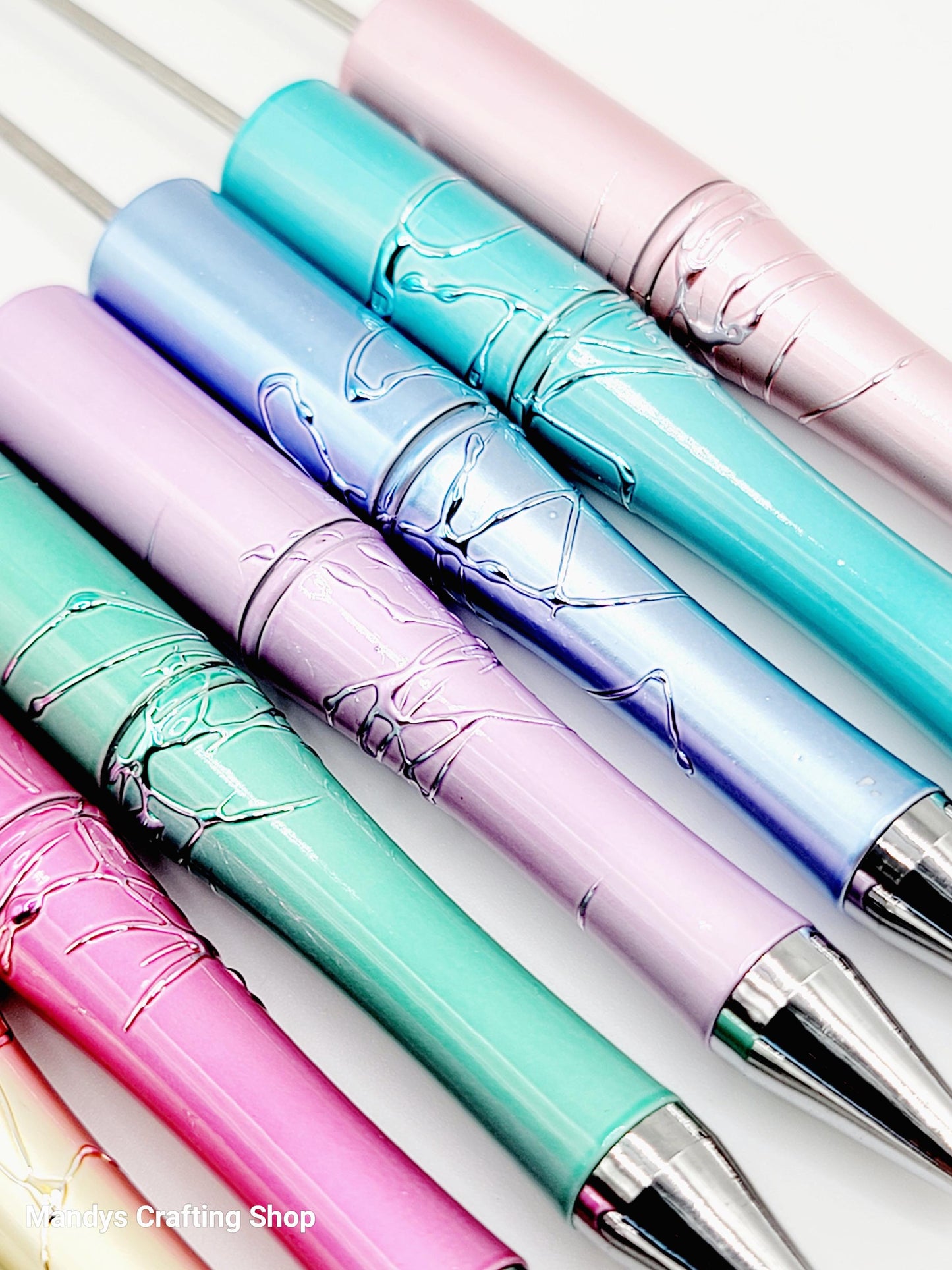 Colorful pens with decorative designs on a white background