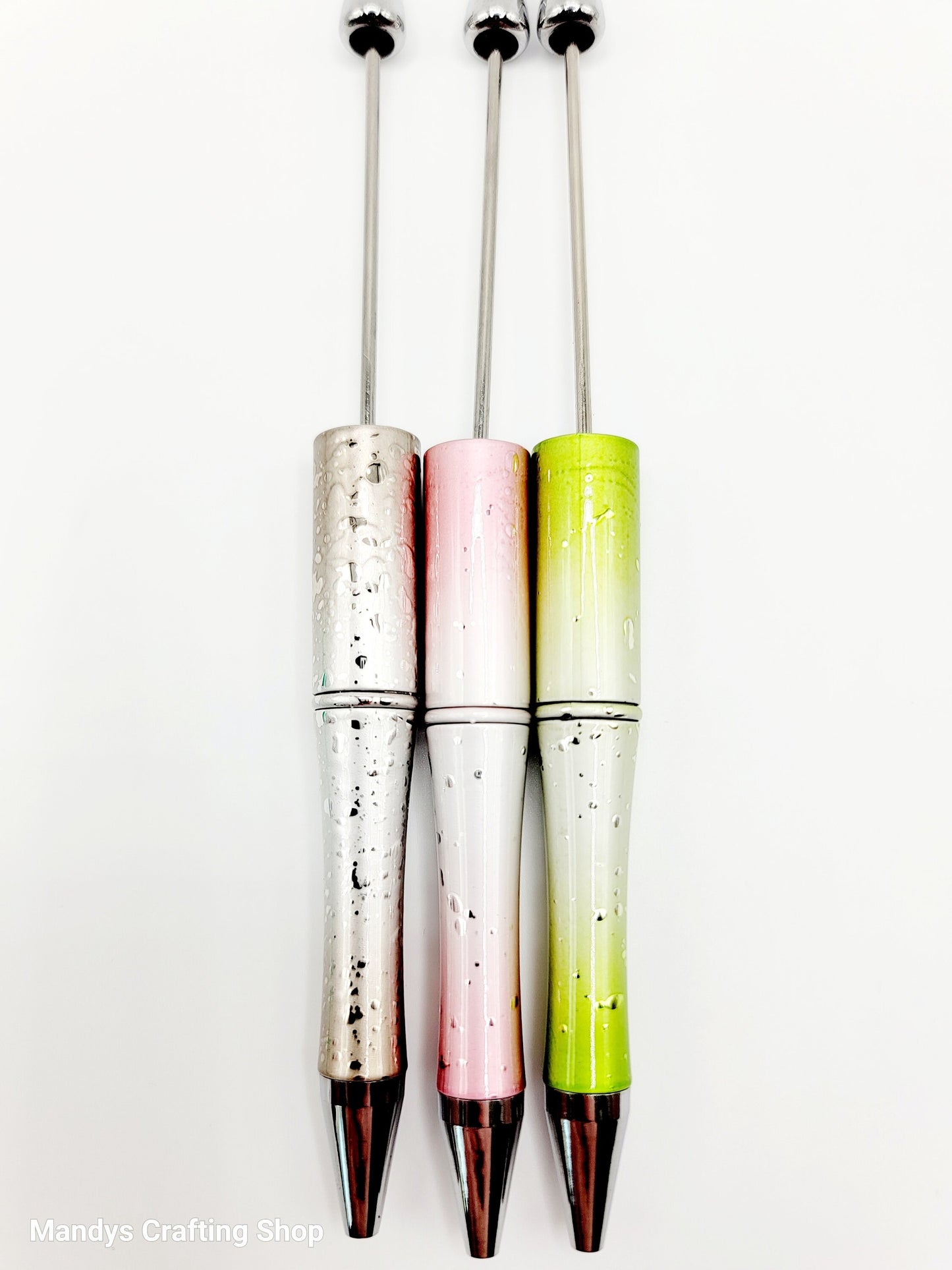 Three colorful pens with gradient designs on a white background