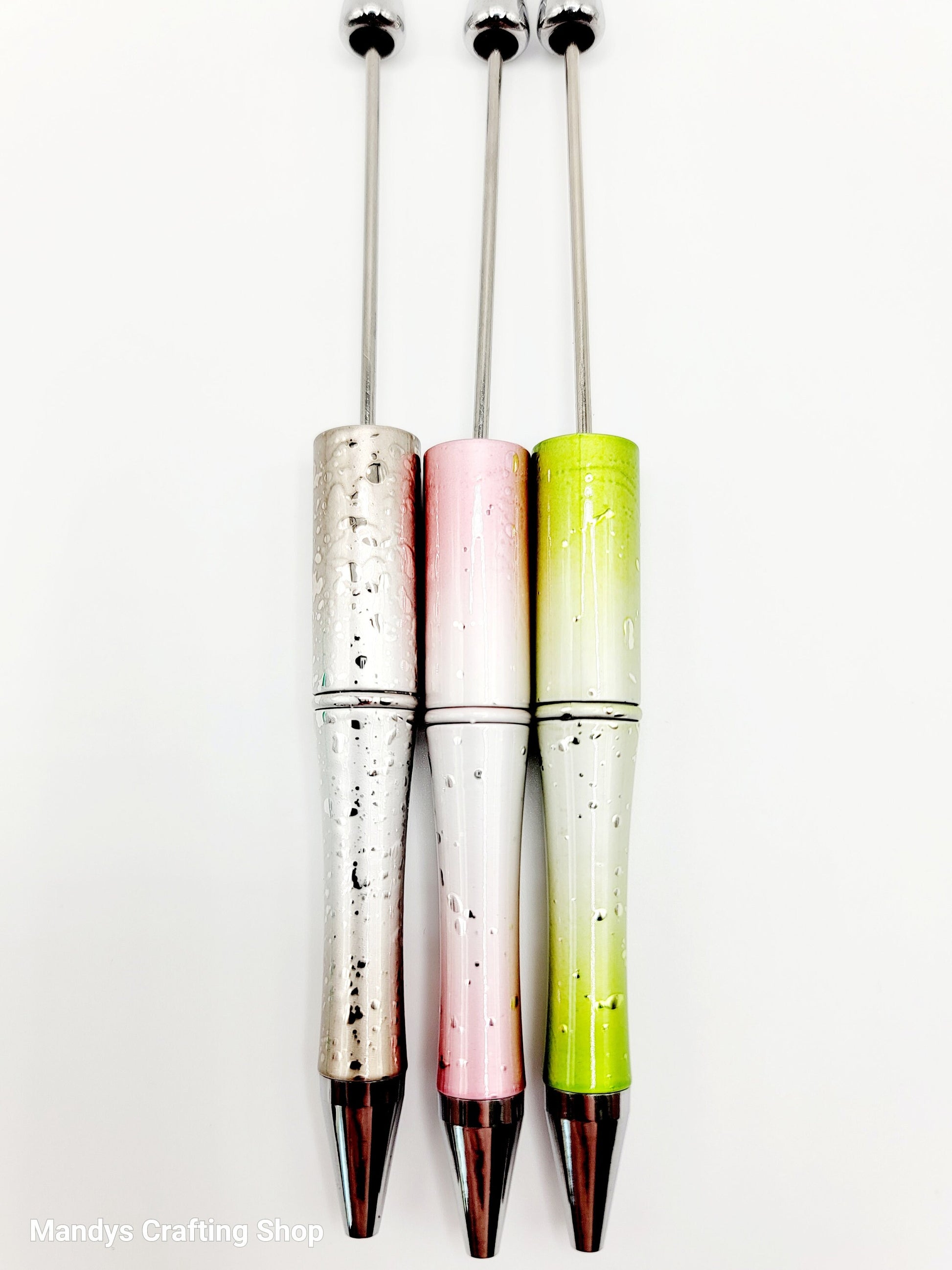 Three colorful pens with gradient designs on a white background