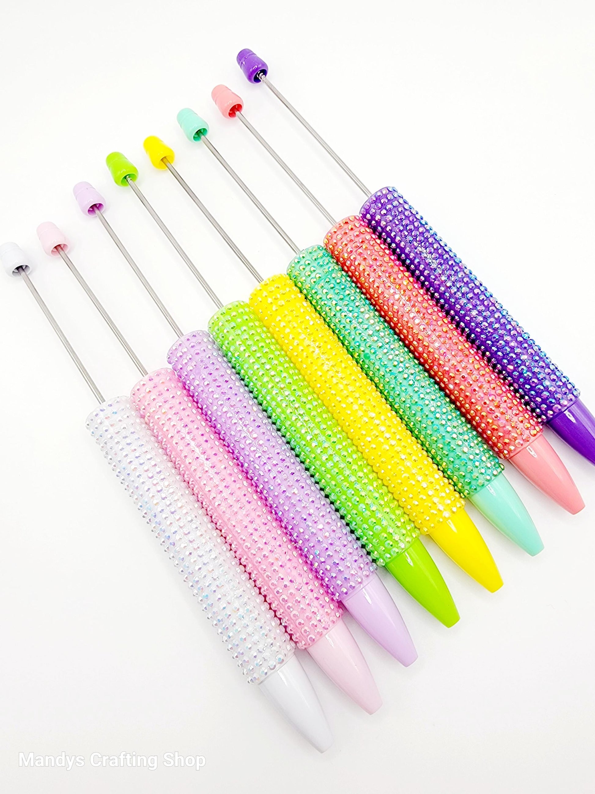 Set of colorful crochet hooks on a white background
