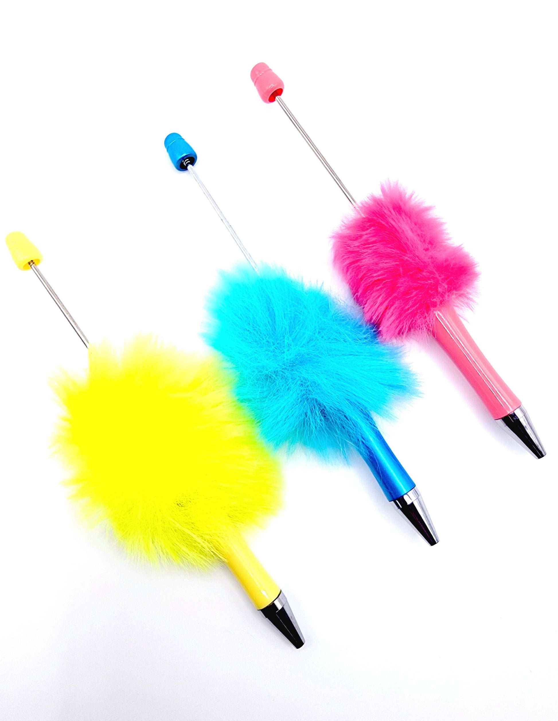 Three colorful feather dusters on a white background