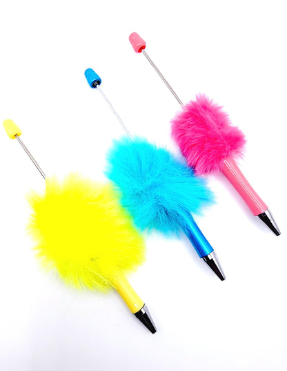 Three colorful feather dusters on a white background