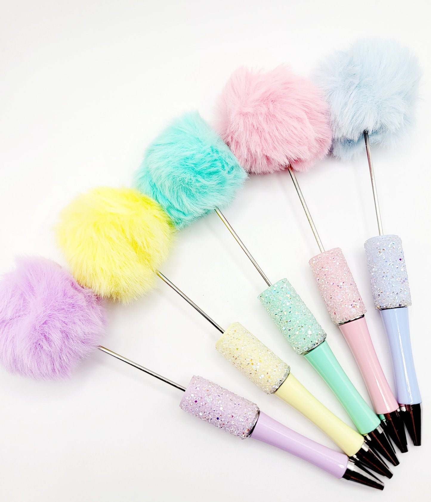 Set of colorful pom-pom pens on a white background