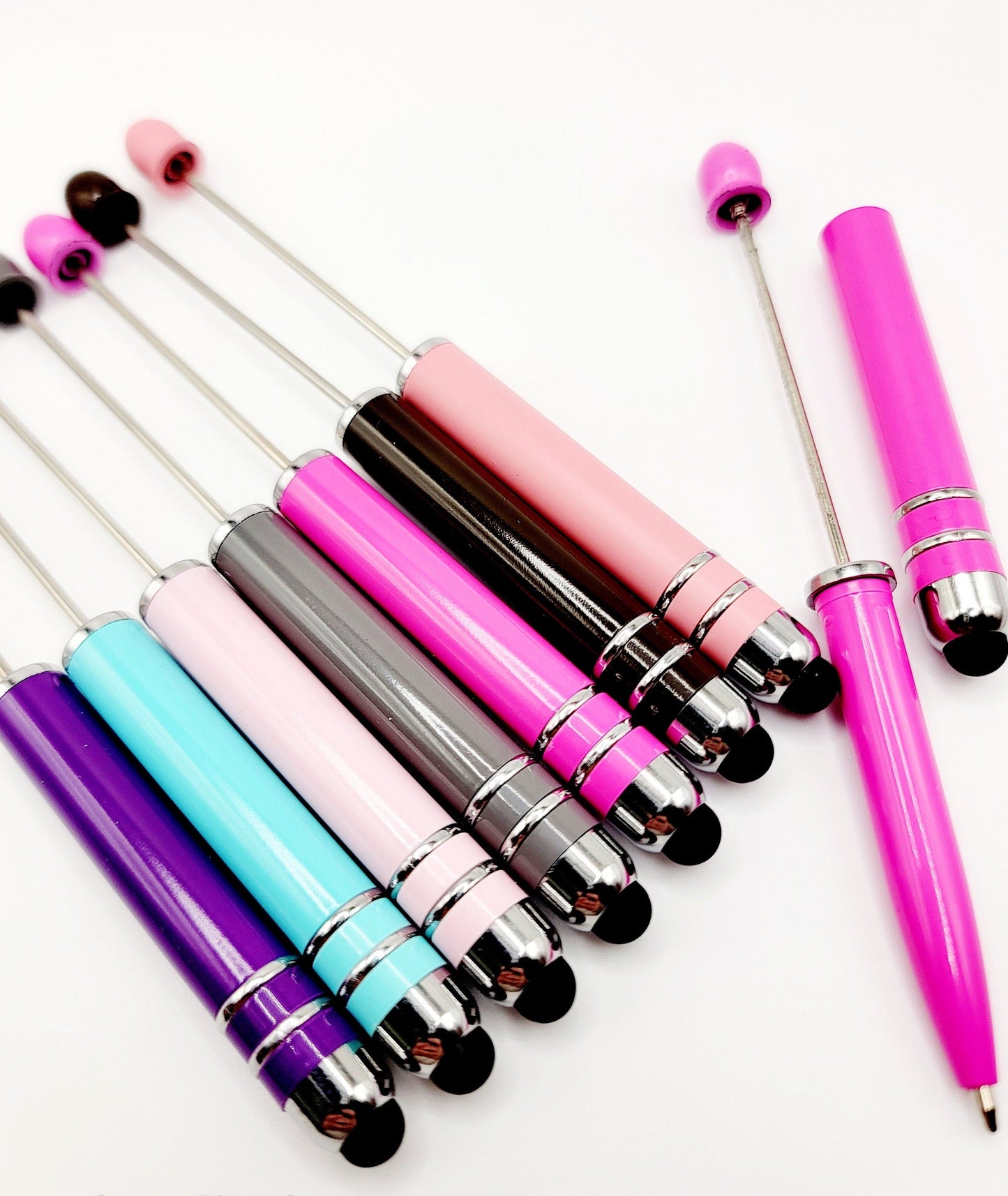 Set of colorful pens with metallic accents on a white background