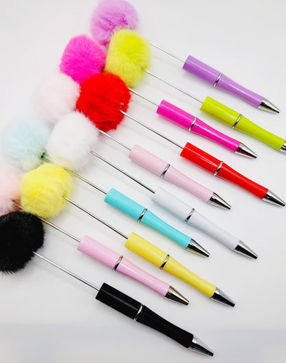 Colorful pens with pom-pom ends on a white background, featuring the brand 'Mandy's Crafting Shop'.