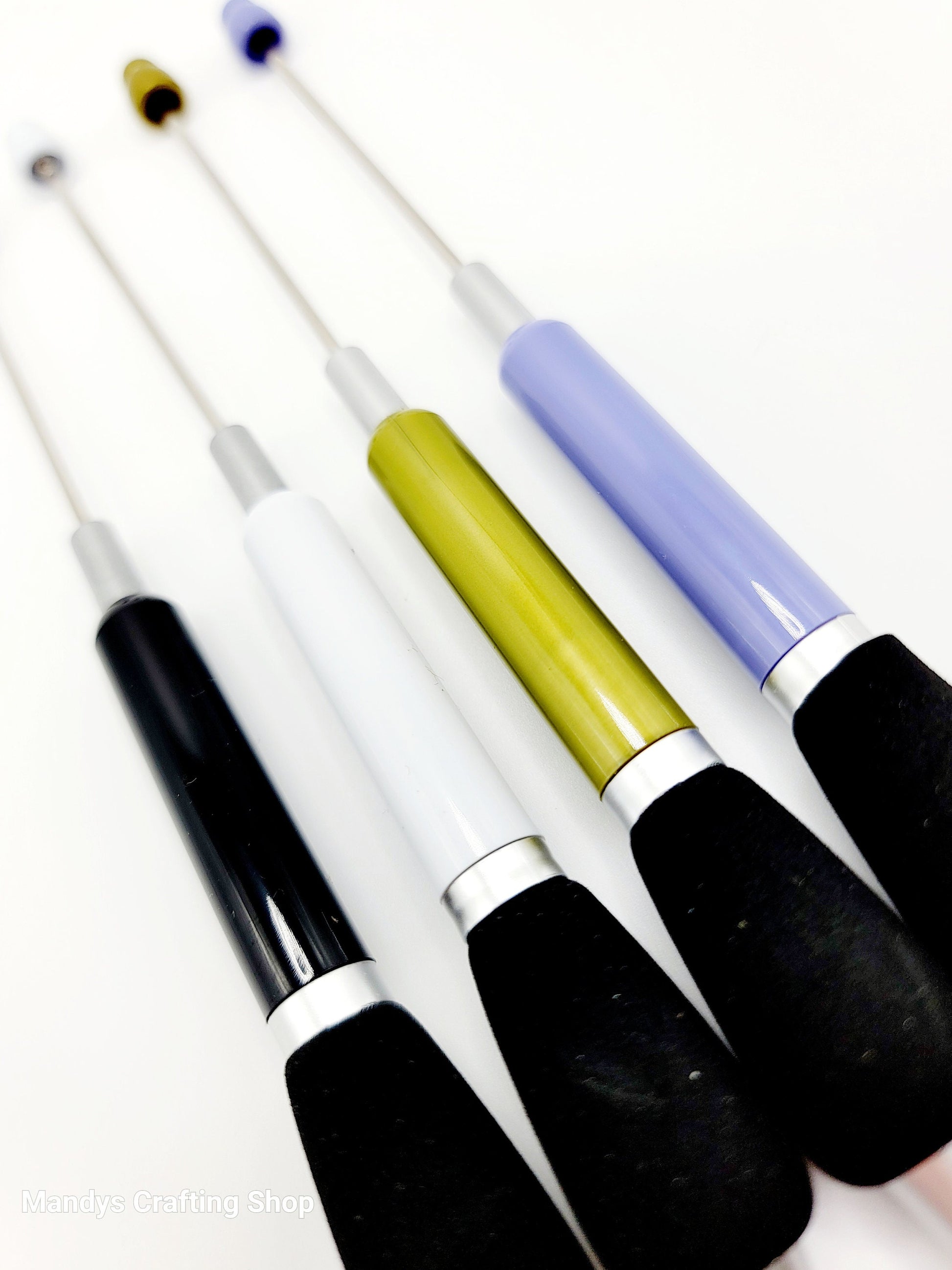 Set of pens with colorful handles on a white background