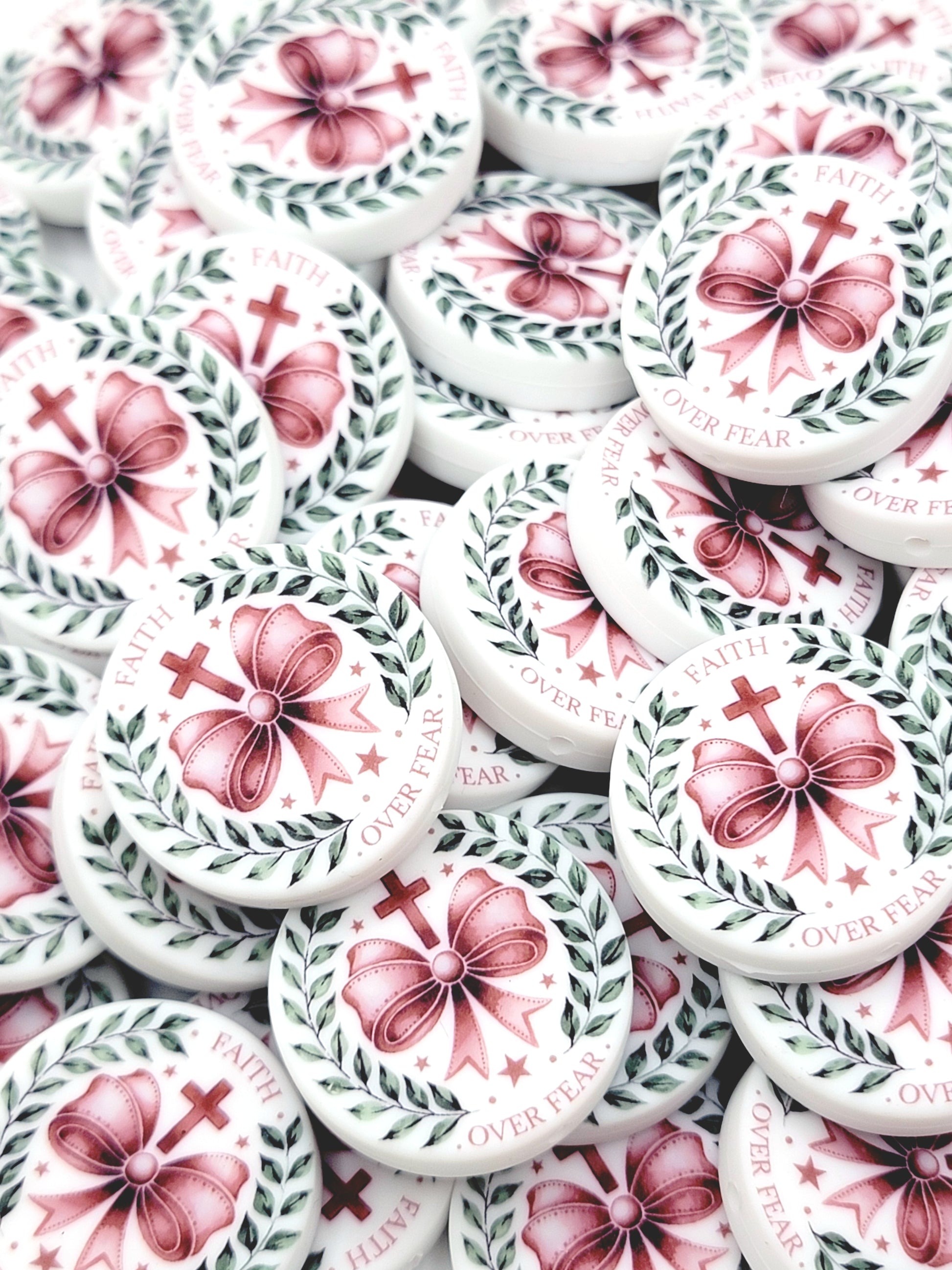 White buttons with pink floral designs and 'Never Fear' text on a white background