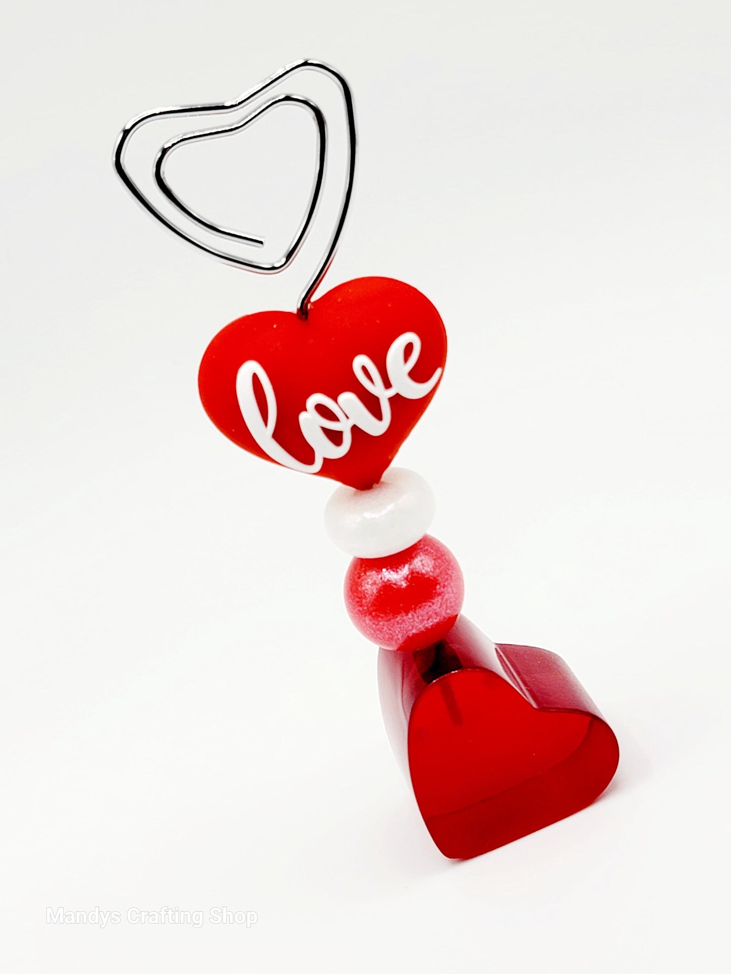 Decorative heart-shaped ornament with 'love' text on a white background