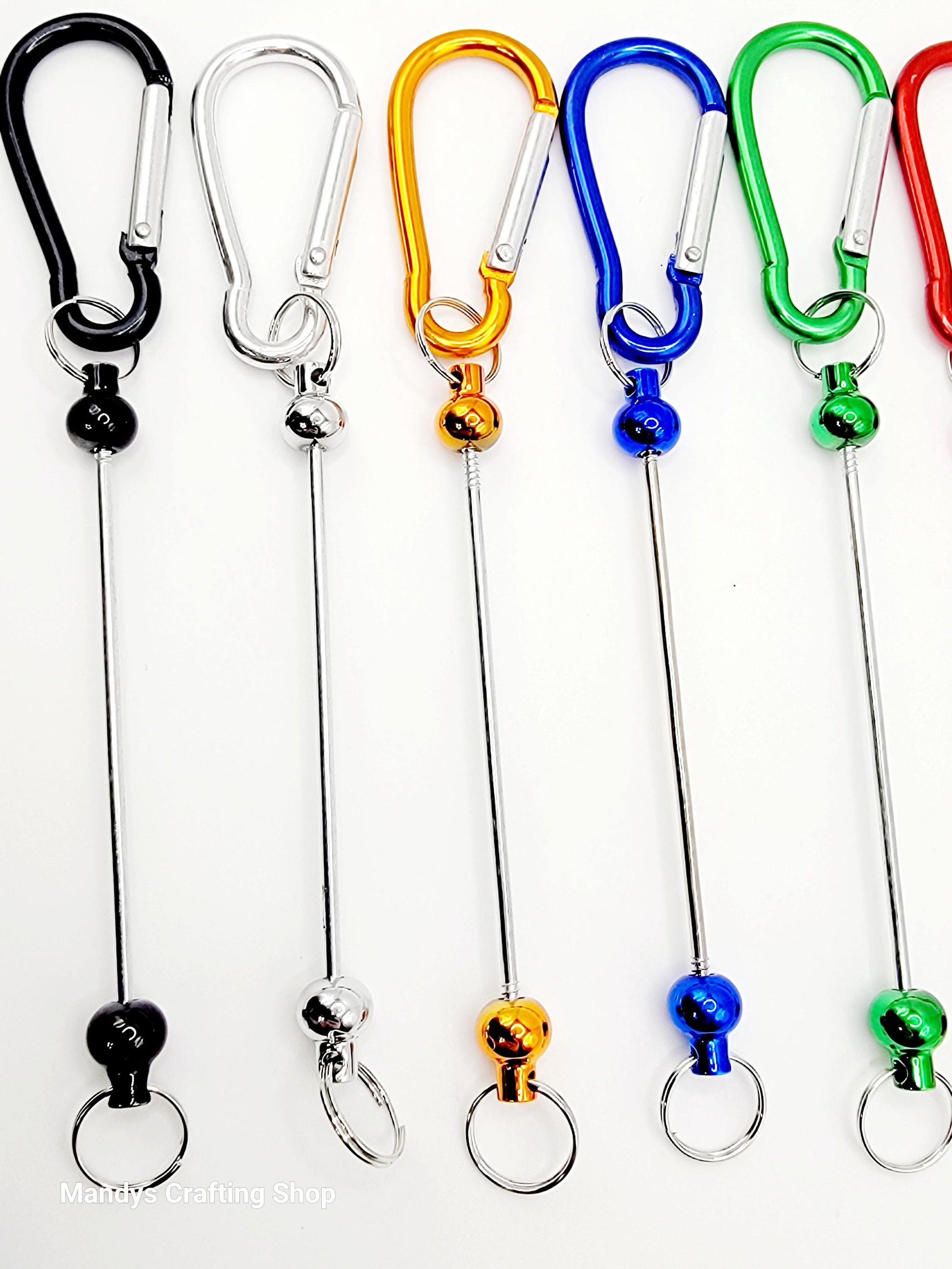 Set of colorful keychain carabiners on white background