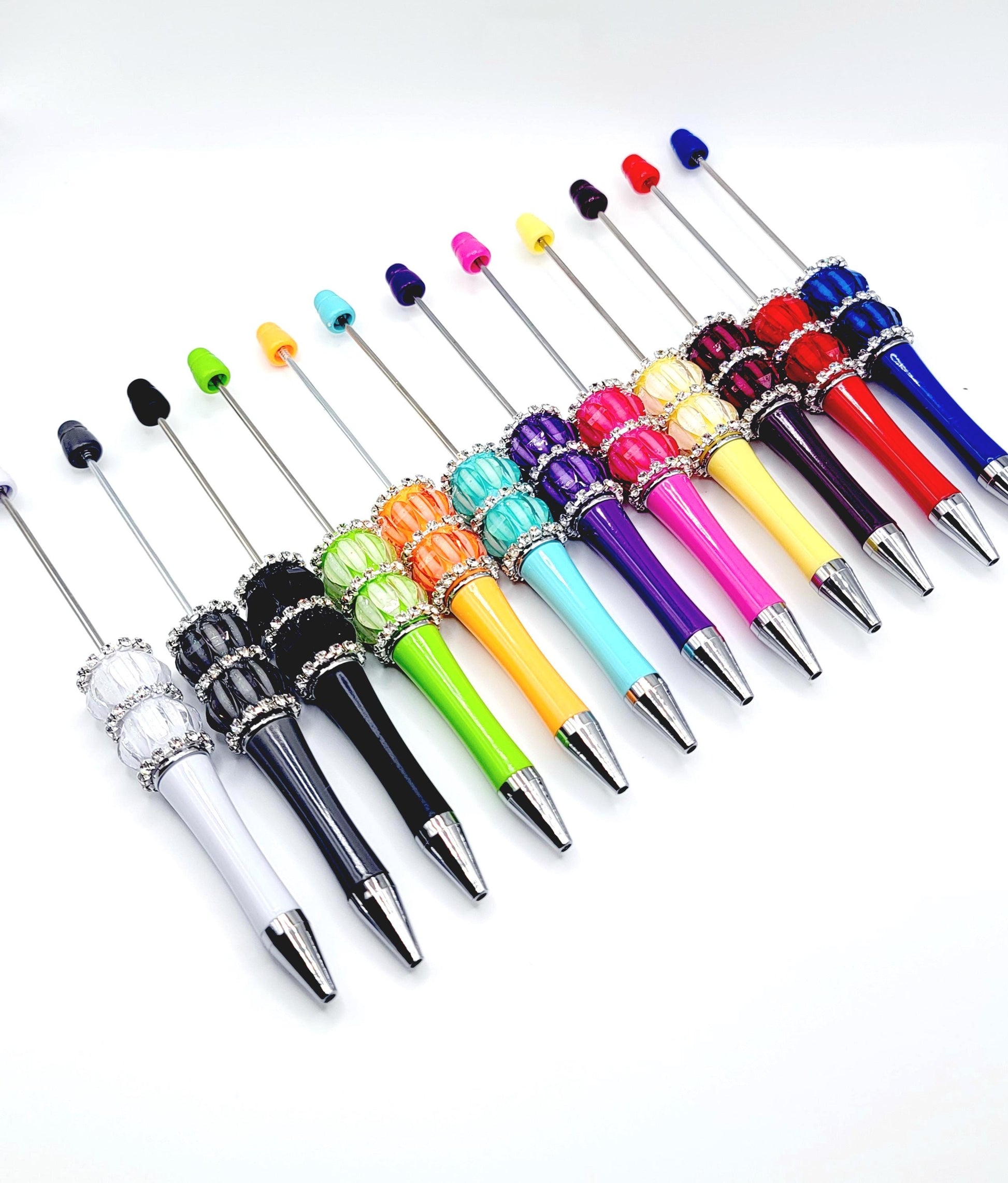 Assorted colorful pens with decorative elements on a white background