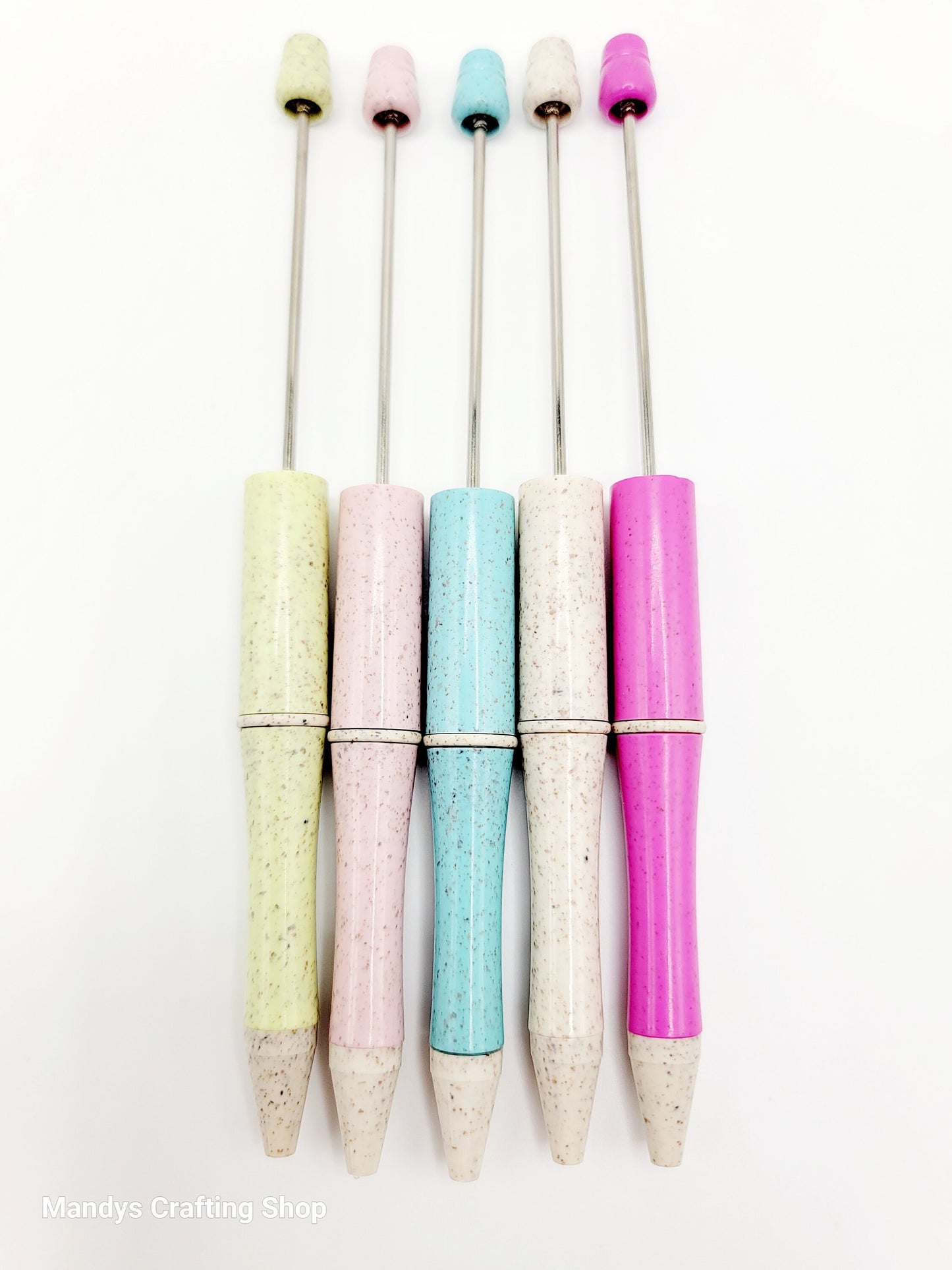 Set of colorful pens with speckled grips on a white background