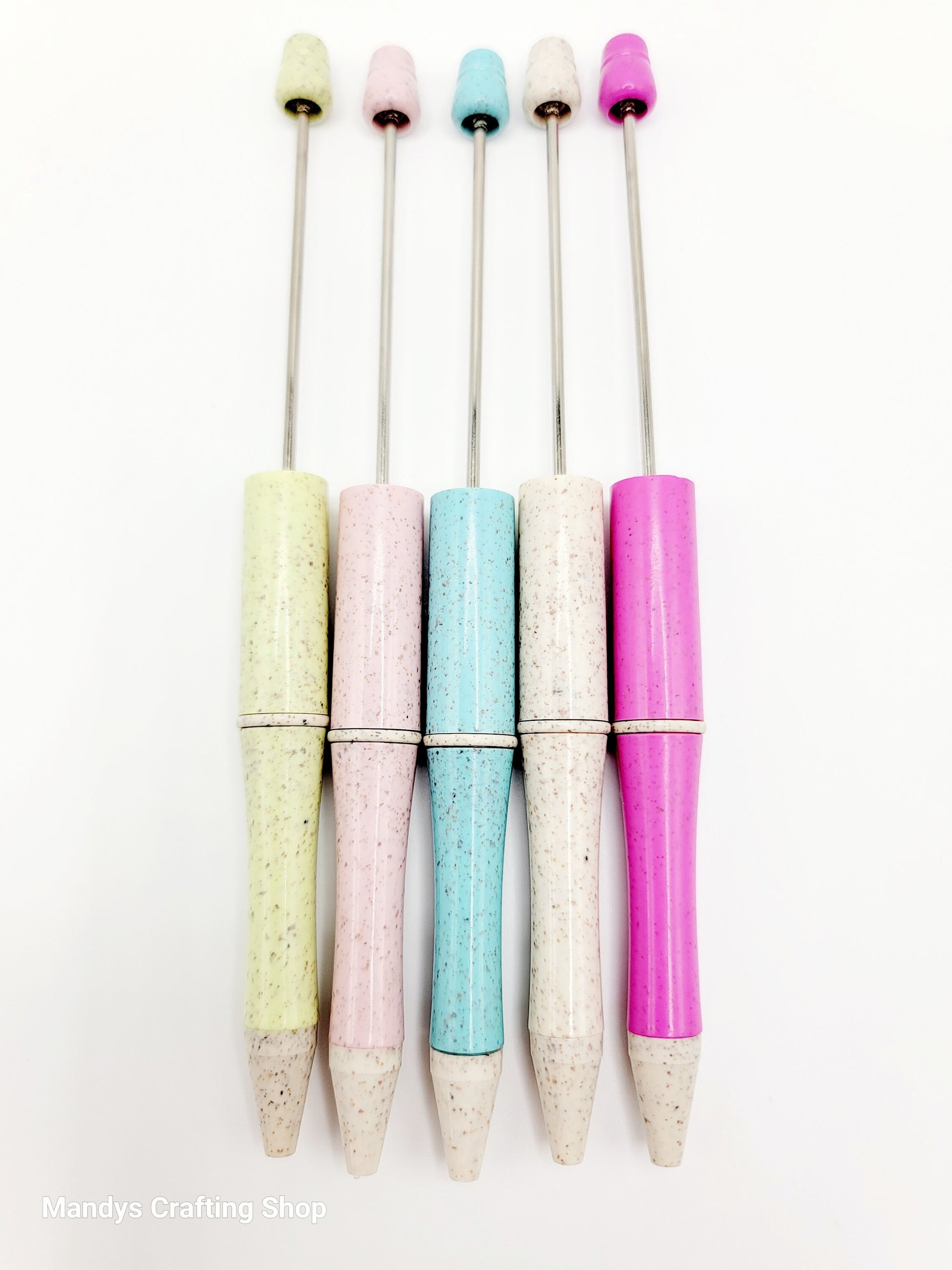 Set of colorful pens with speckled grips on a white background