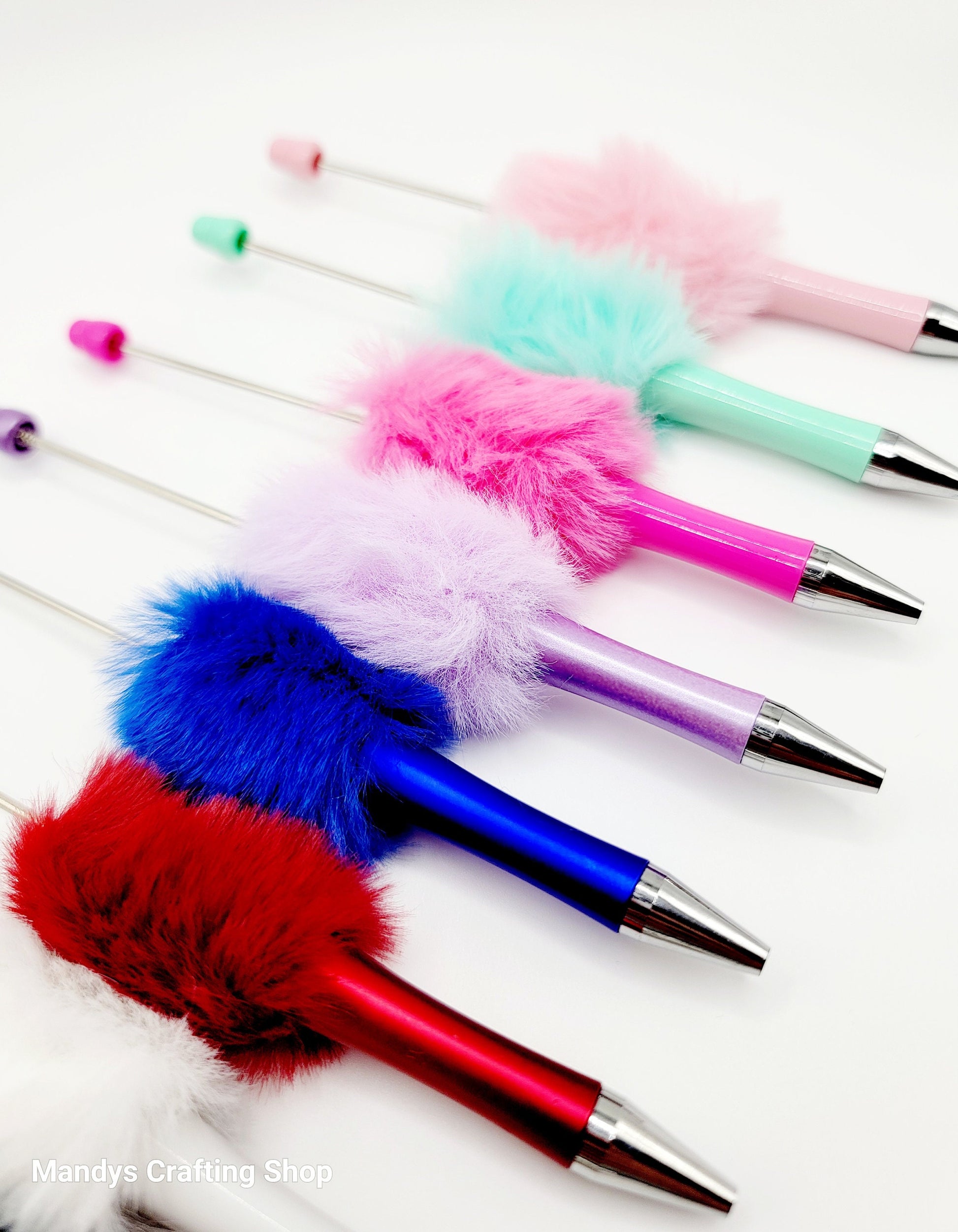 Colorful pens with fluffy tips on a white background