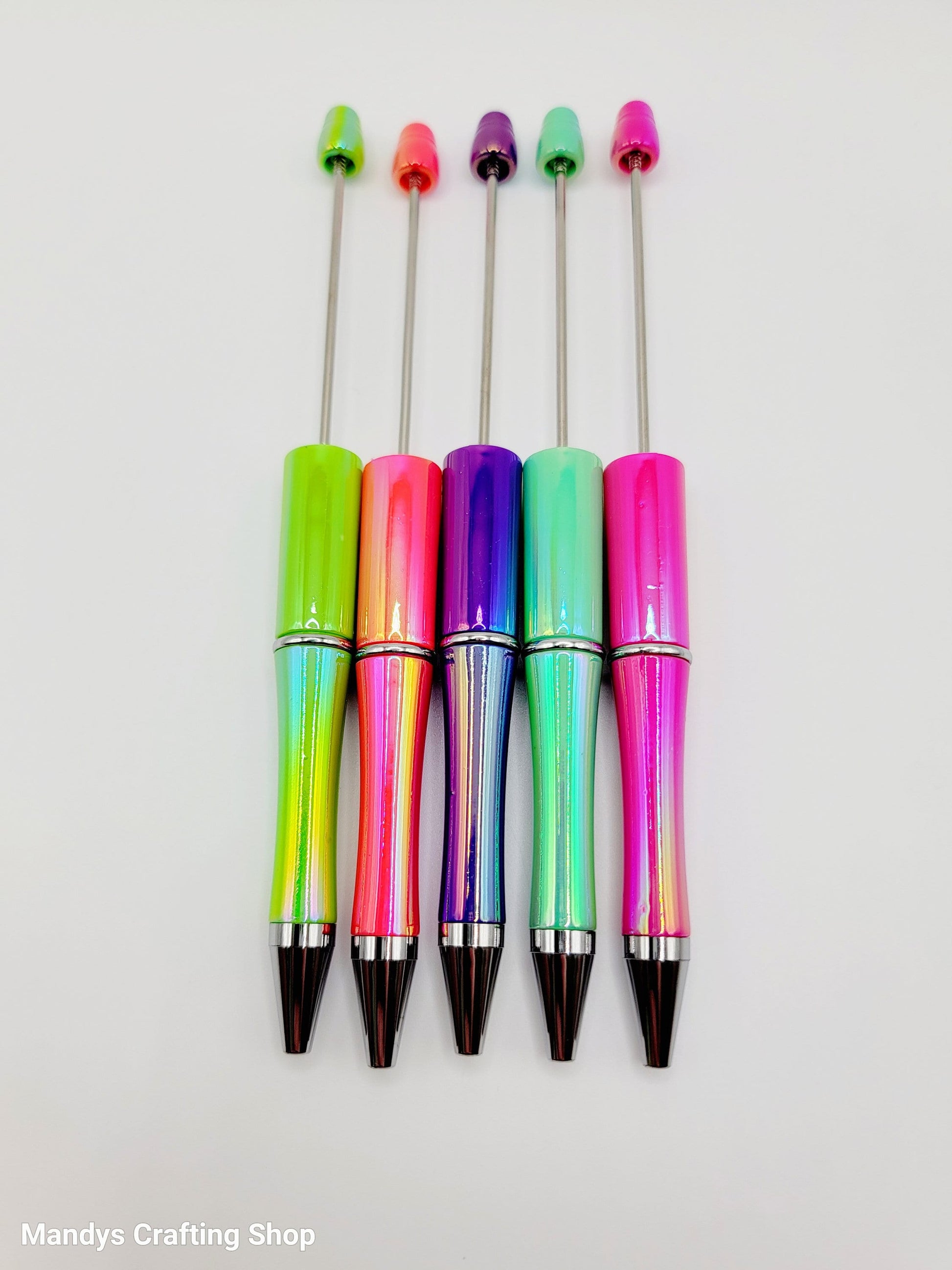 Five colorful pens with multicolored accents on a white background