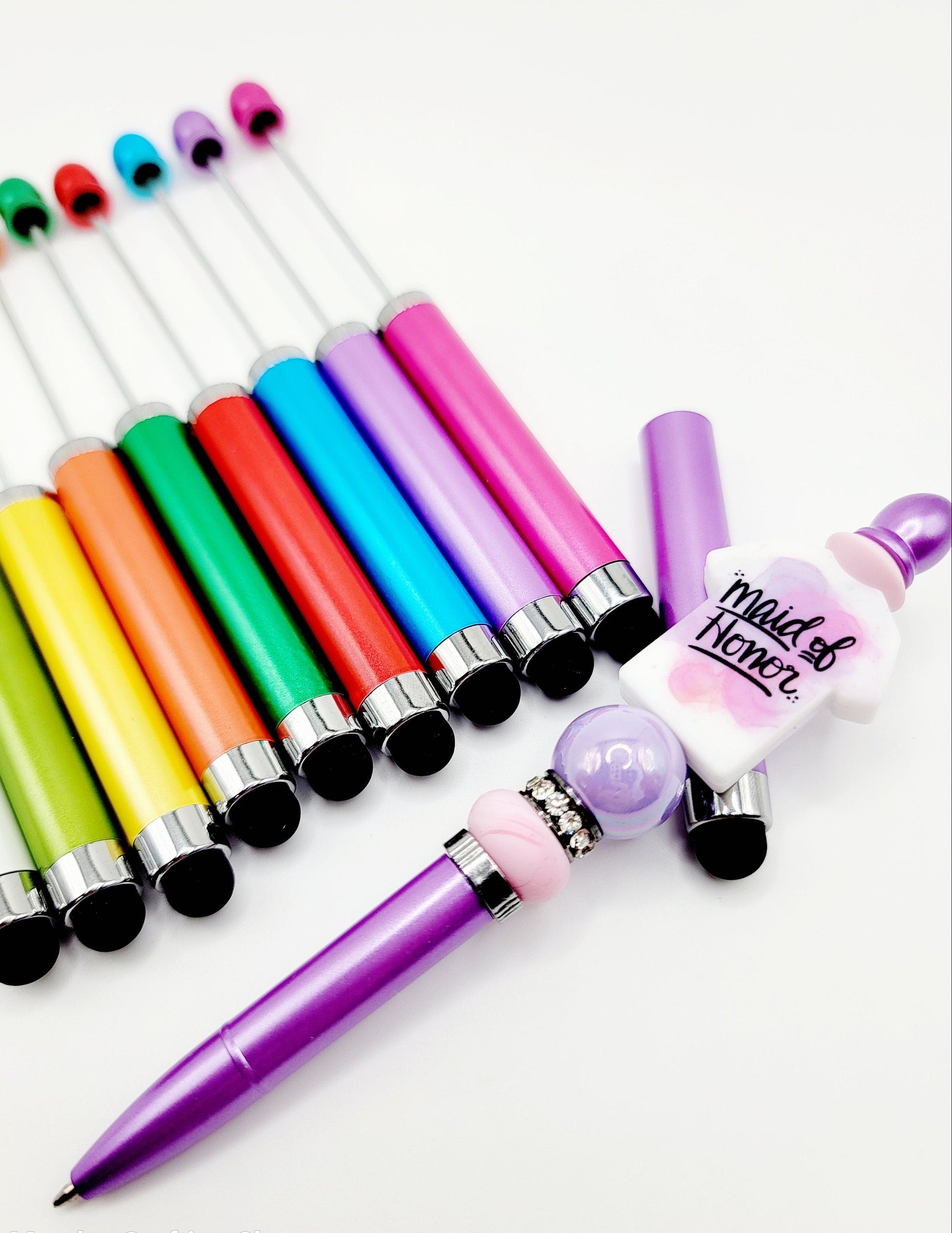 Colorful pens with different designs on a white background