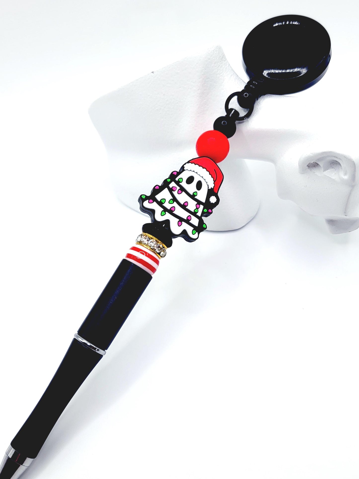 Pen with a decorative top featuring a Santa Claus design on a white background