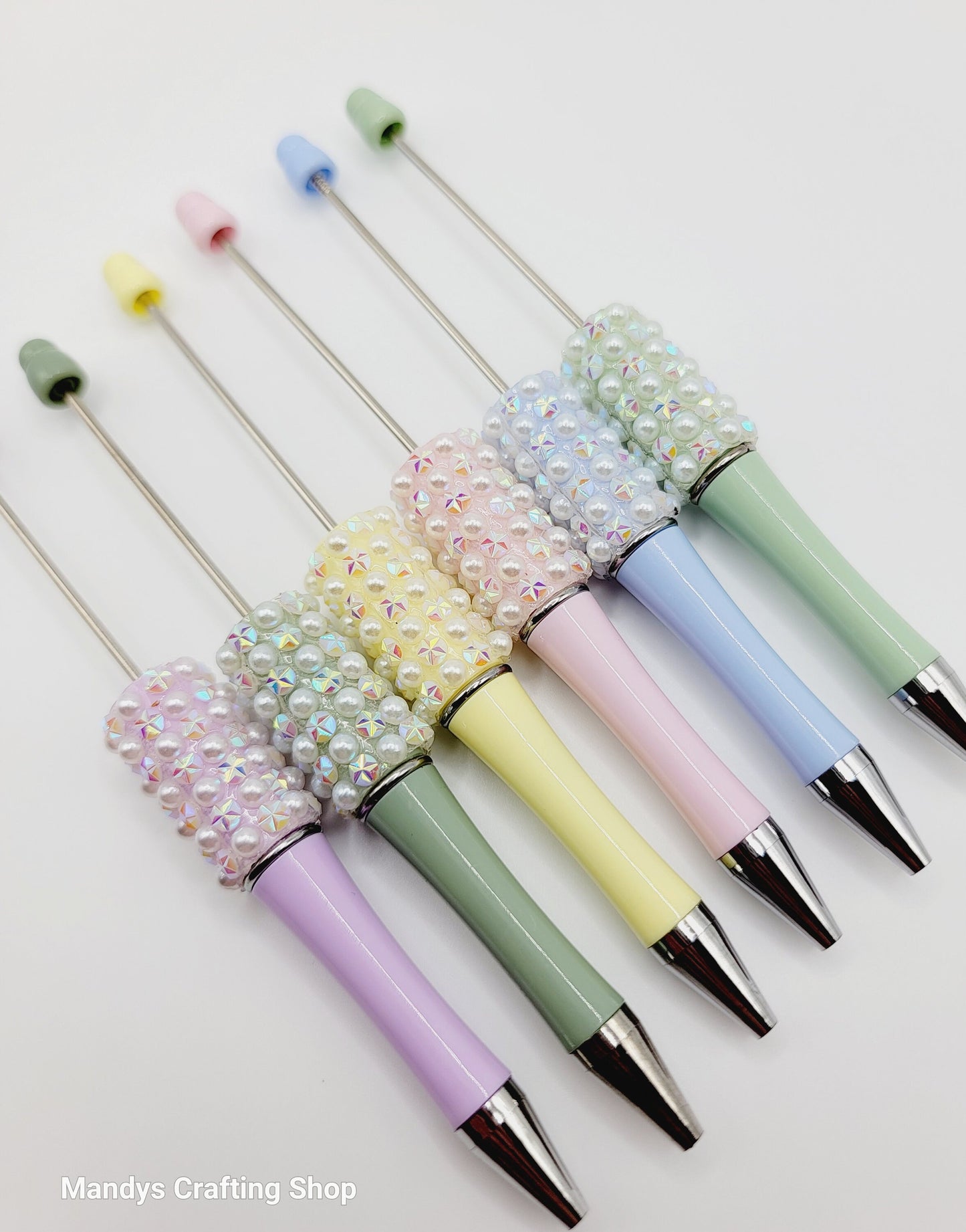 Set of colorful pens with decorative ends on a white background, branded 'Mandys Crafting Shop'.