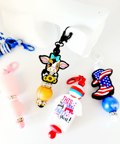 Collection of colorful keychains and charms on a white background