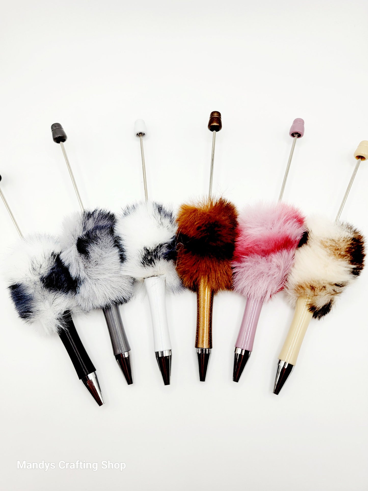 Set of decorative pens with fur tips on a white background