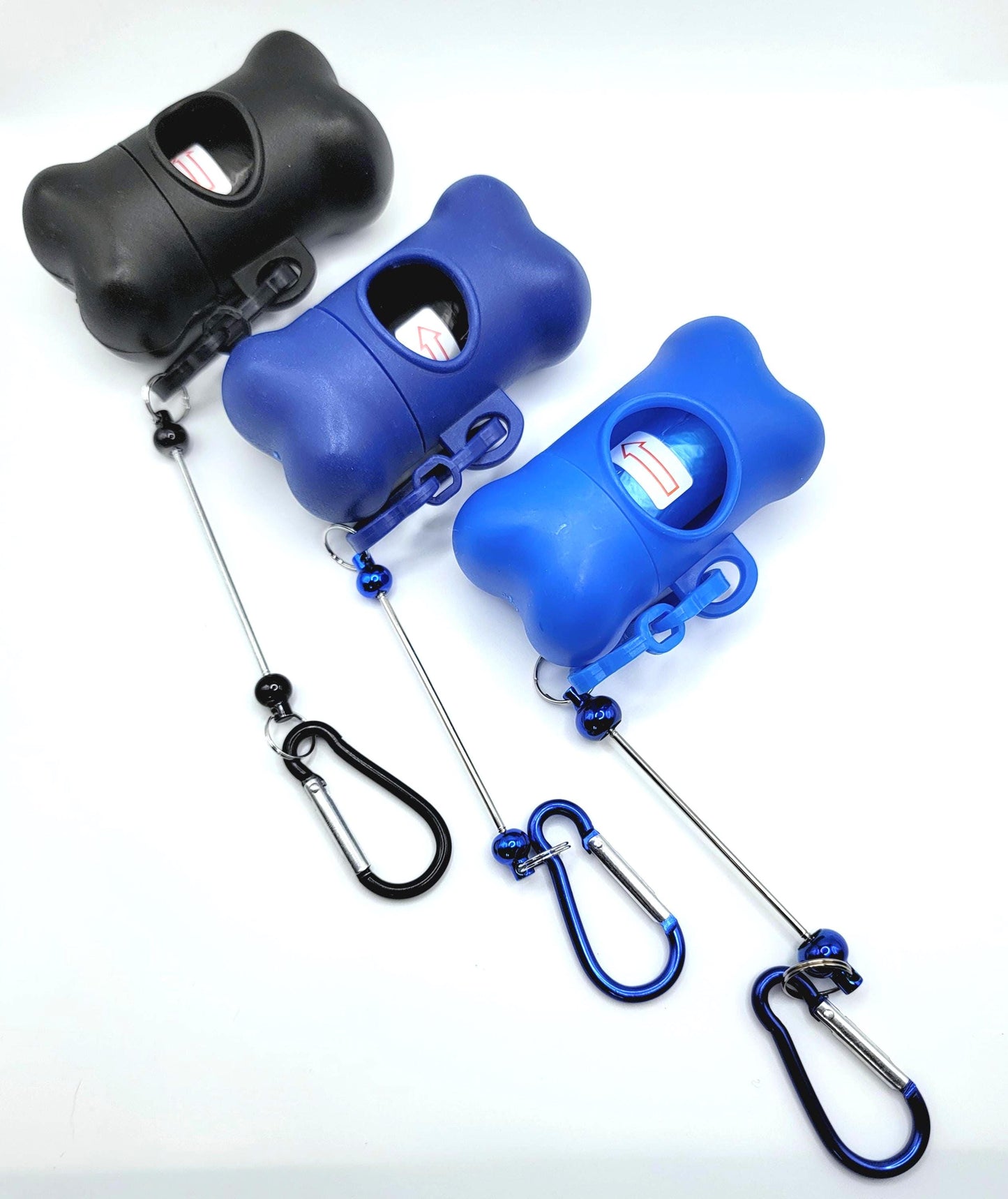 Three dog waste bags dispensers in black, blue, and another blue color on a white background.