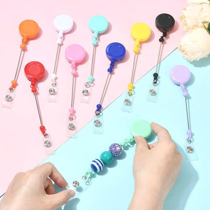 Colorful badge holders with beads on a pink and blue background
