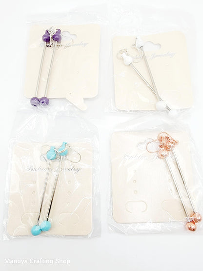 Set of four decorative sticks with colorful beads on a white background, branded 'Mandy's Crafting Shop'.