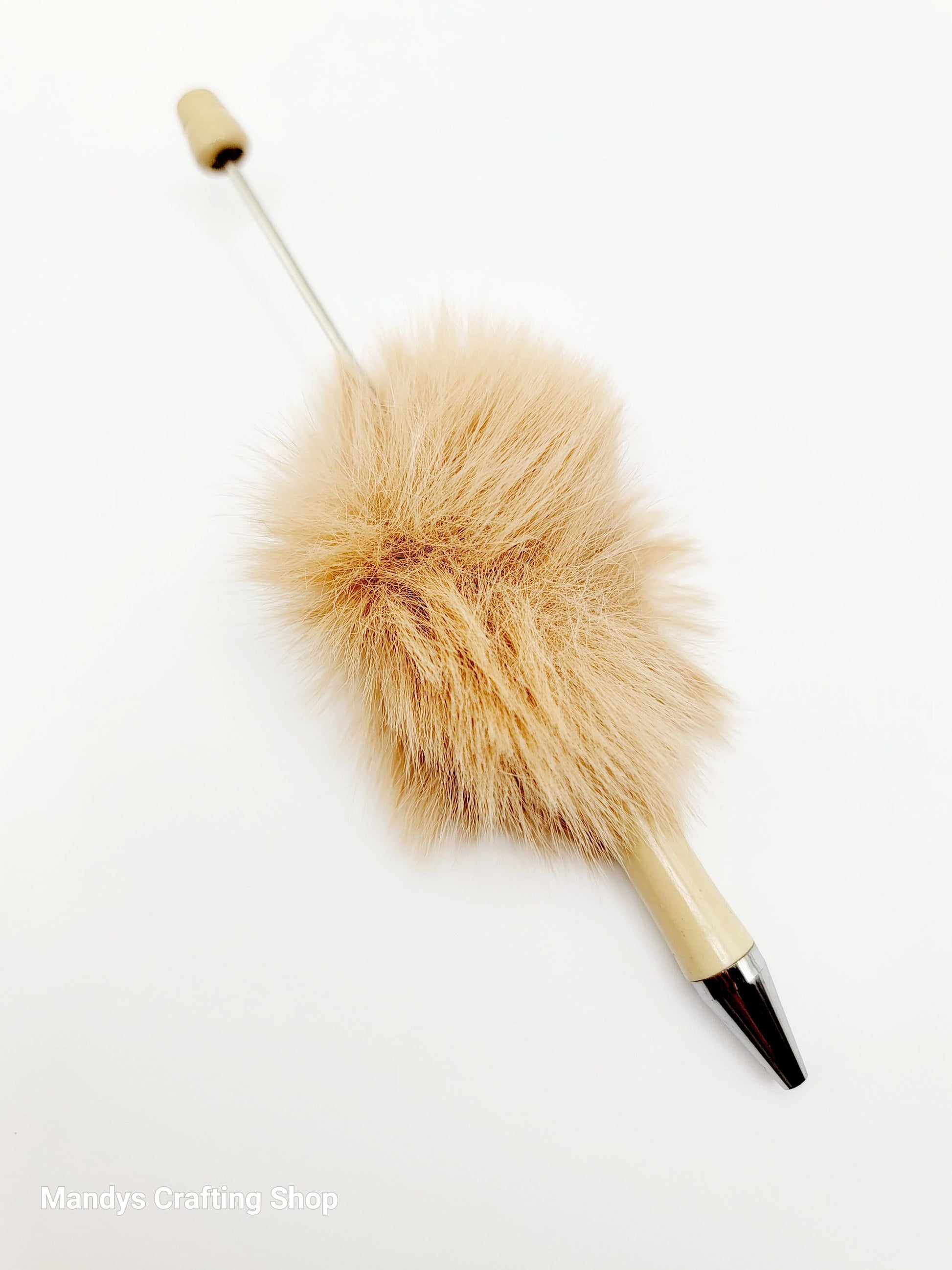 Decorative pen with fluffy beige top and black and silver bottom on a white background