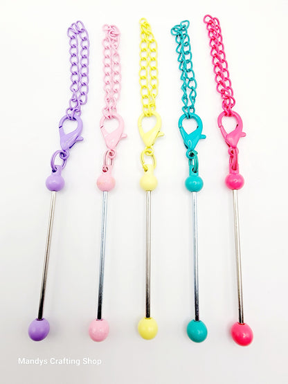 Set of colorful chain and ball designs on a white background