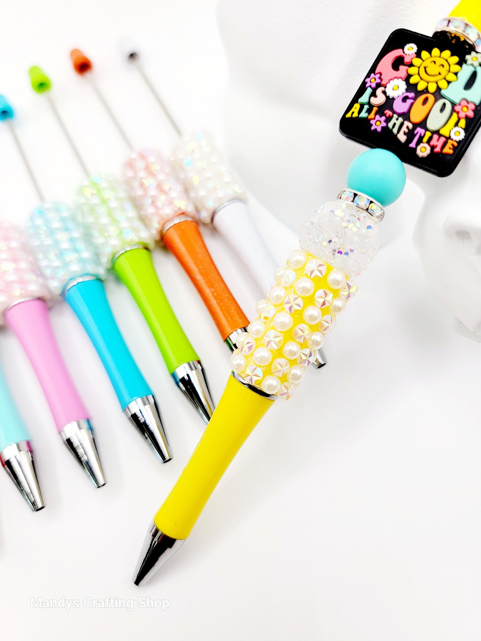 Colorful pens with decorative accents on a white background