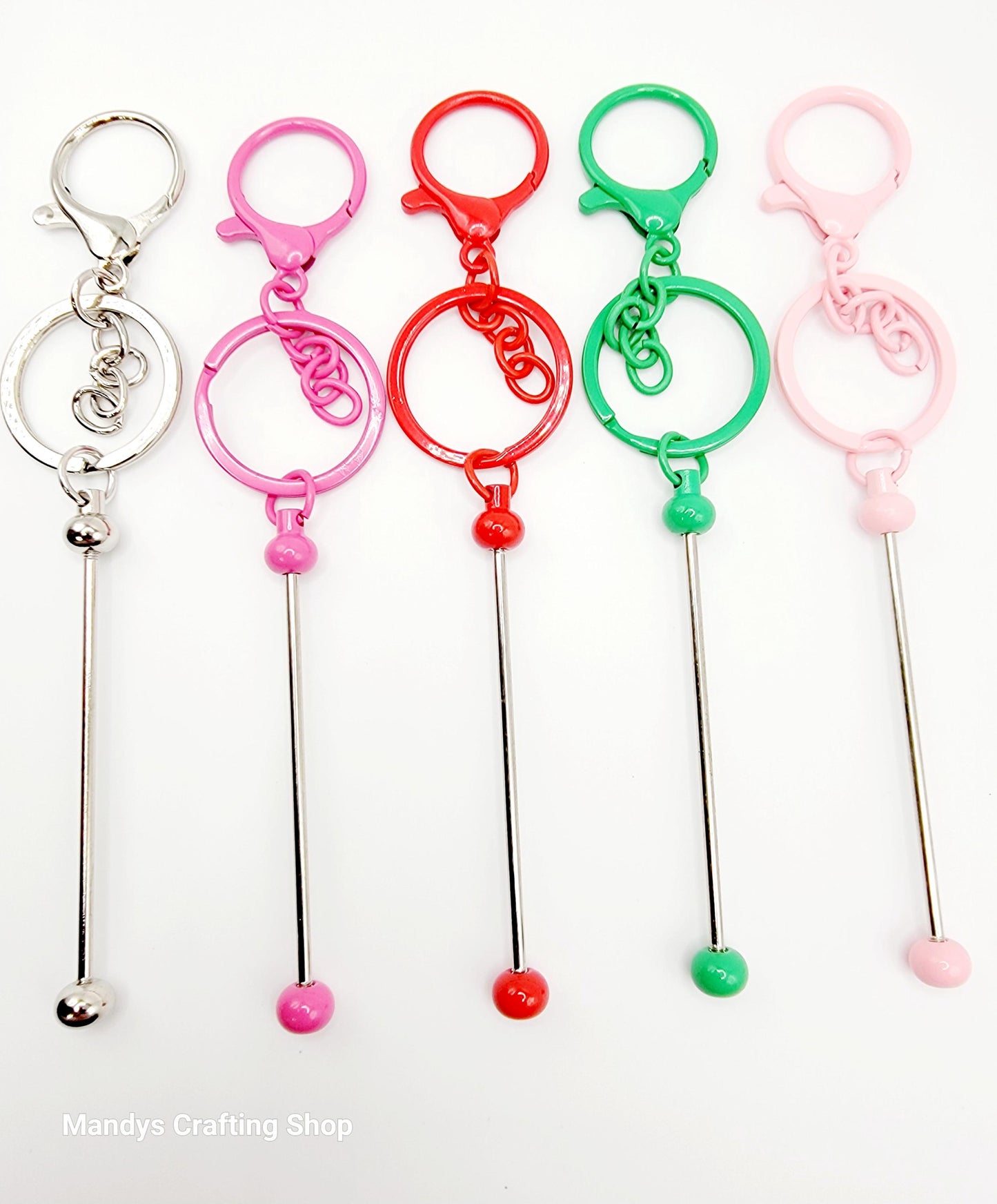 Set of colorful keychain sticks with different colored ends on a white background.