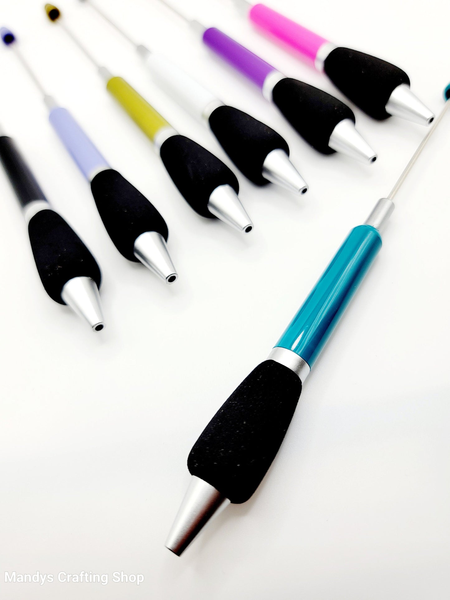 Set of colorful pens with black handles on a white background