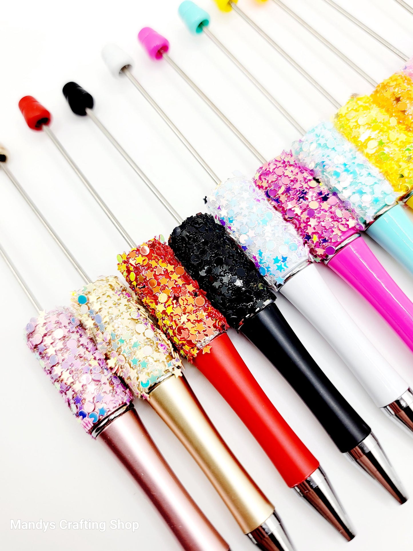Colorful glittery pens on a white background