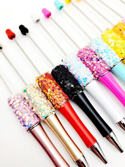 Colorful glittery pens on a white background
