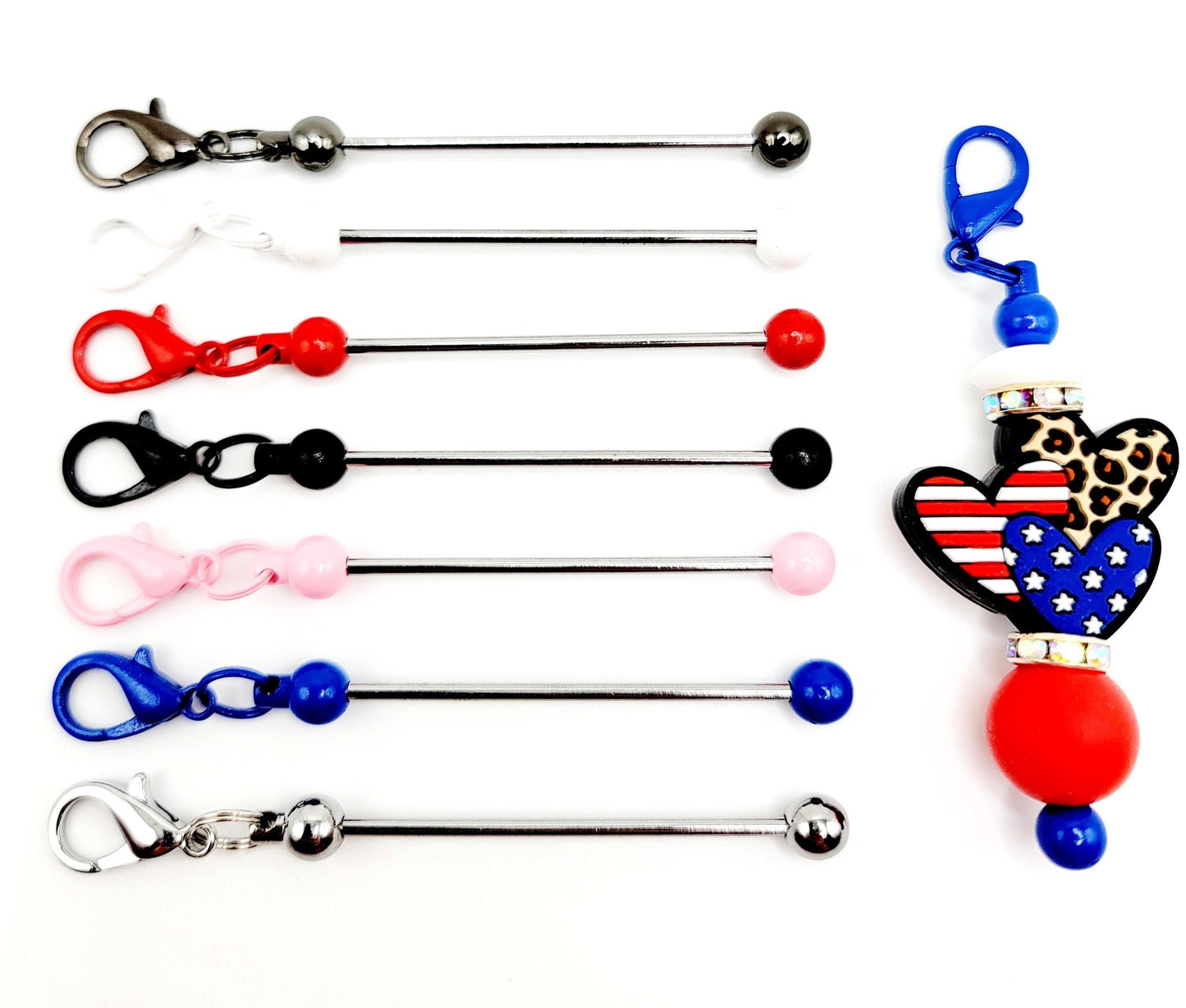 Collection of colorful keychain extenders with various attachments on a white background