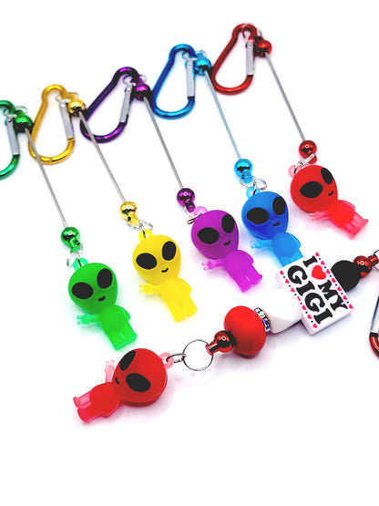 Colorful keychains with various designs on a white background