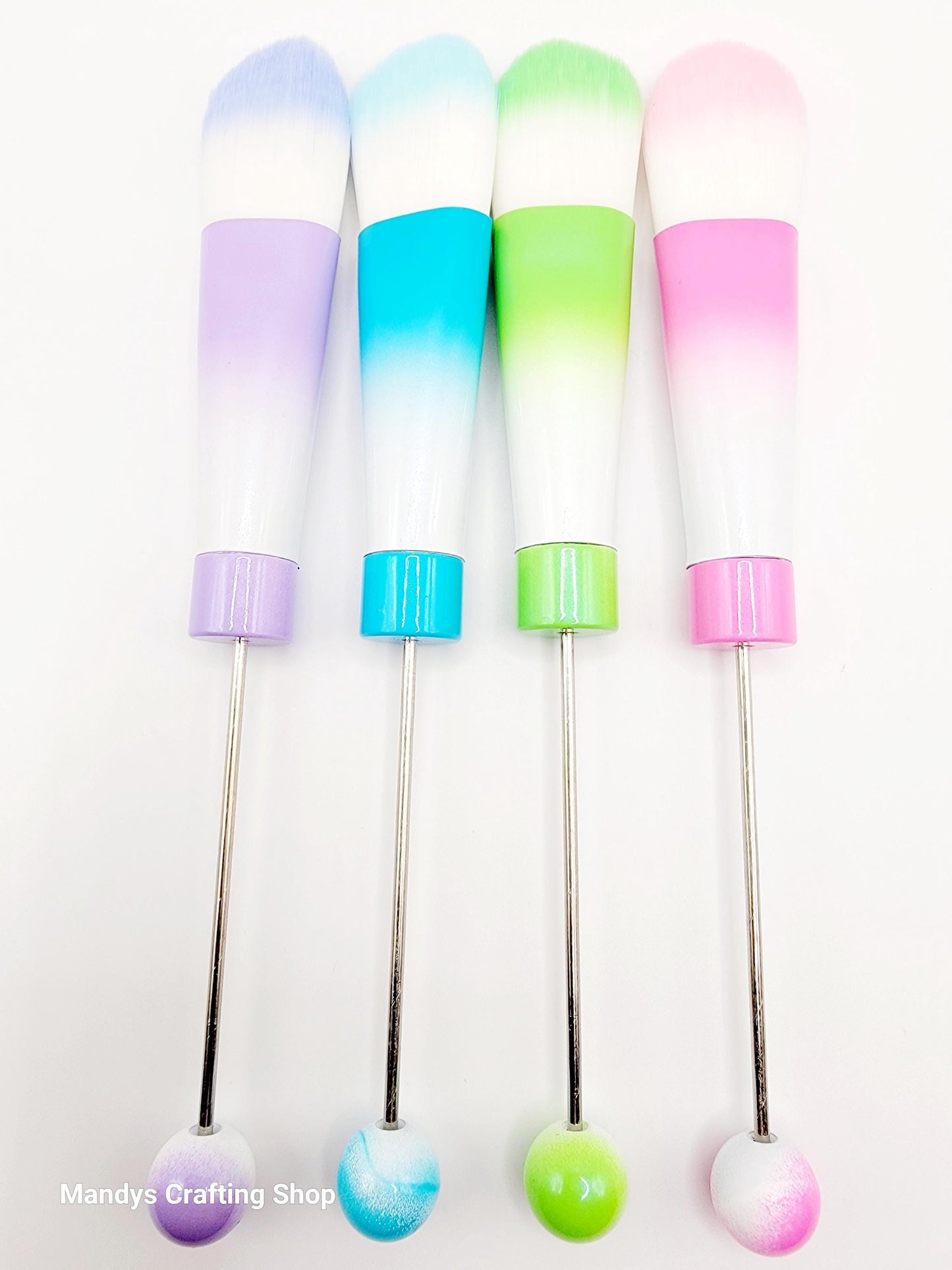 Set of colorful cocktail stirrers with gradient tips on a white background