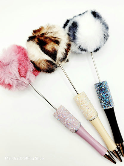 Decorative sticks with fluffy ends and glittery handles on a white background