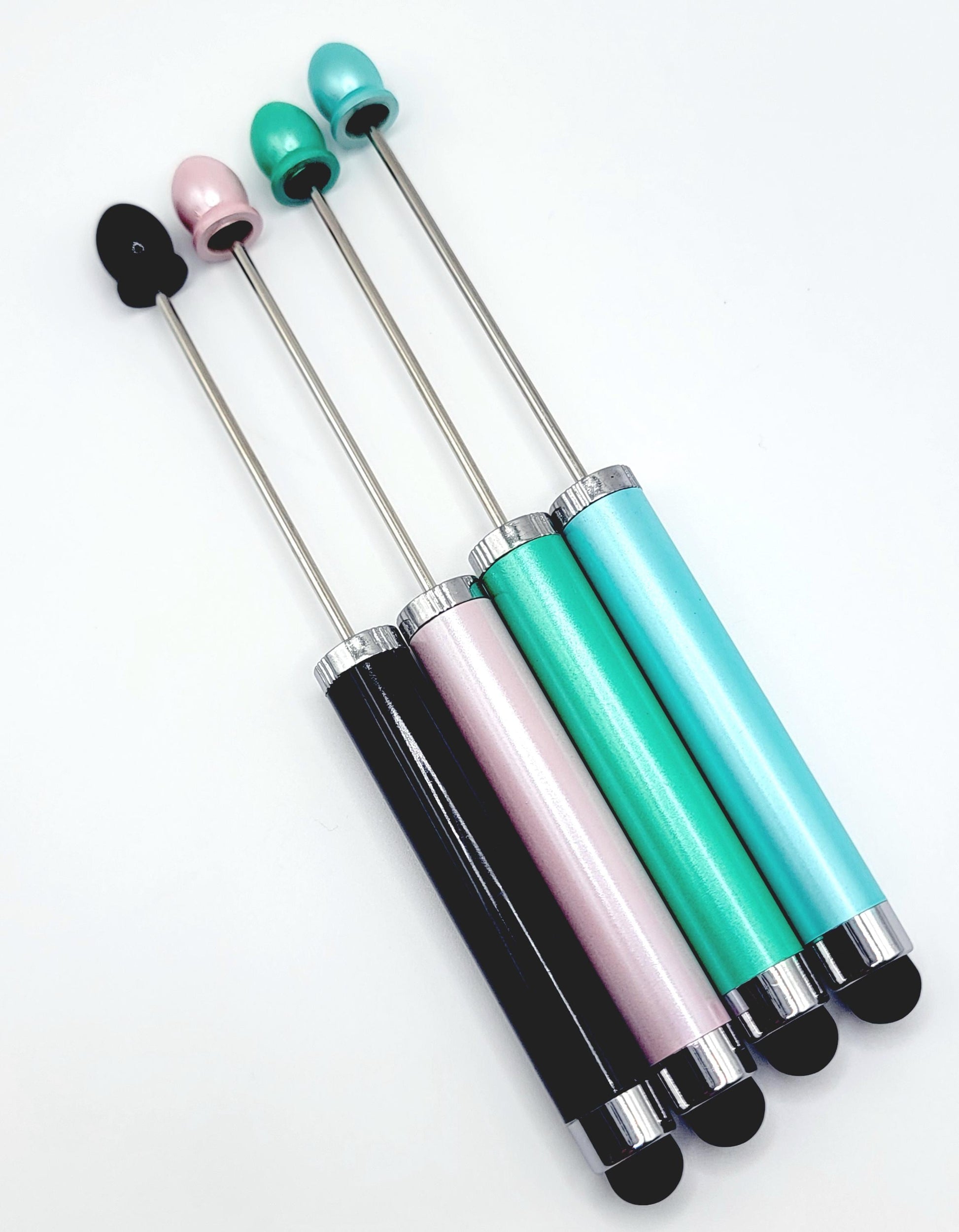 Set of four stylus pens with different colored tips on a white background