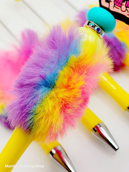 Colorful feather duster with a turquoise top on a white surface