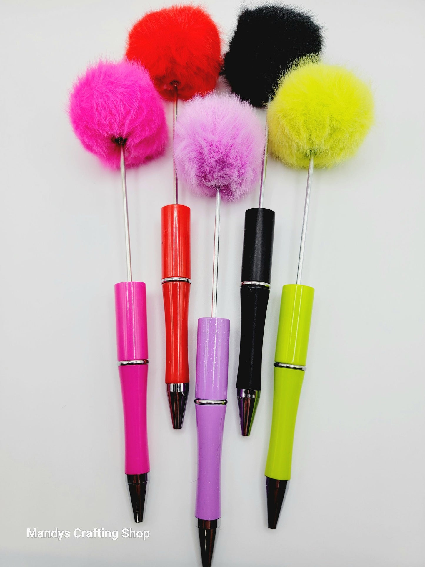 Colorful pens with fuzzy ends on a white background