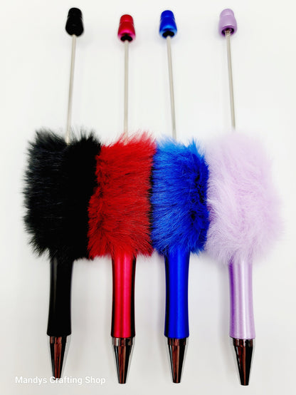 Four colorful pens with fuzzy ends on a white background