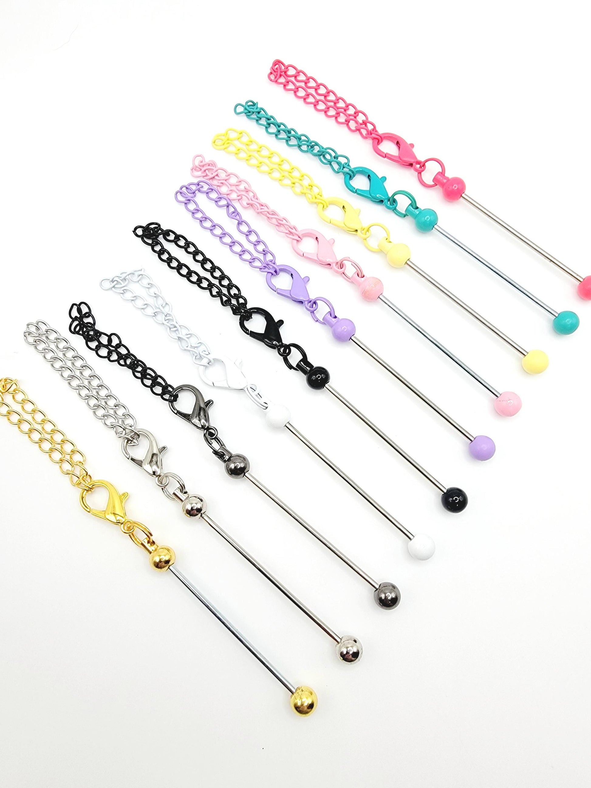 Set of colorful jewelry sticks with various chain and clasp designs on a white background